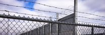 Chain-link and barbed wire security perimeter fencing