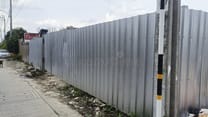 Corrugated steel hoarding fence around a construction site